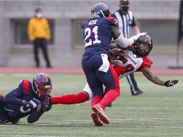 Montreal Alouettes Greg Reid and Chris Ackie team up to take down Ottawa Redblacks running back De'Lance Turner during Canadian Football League game in Montreal Monday October 11, 2021.