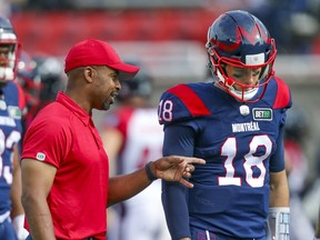 Montreal Alouettes head coach Khari Jones speaks with quarterback Matthew Shiltz prior to game against the Ottawa Redblacks in Montreal on Oct. 11, 2021.