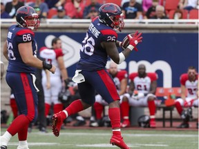Montreal Alouettes tailback Cameron Artis-Payne looks upfield after catching a pass in front of offensive-lineman David Brown during game against the Ottawa Redblacks in Montreal on 11, 2021.
