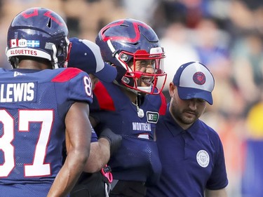 Montreal Alouettes quarterback Vernon Adams Jr. winces in pain as he's helped off the field with an injury during  second half of Canadian Football League game against the Ottawa Redblacks in Montreal Monday October 11, 2021.