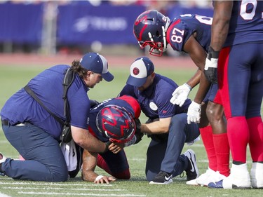 Montreal Alouettes Eugene Lewis leans over to check on injured quarterback Vernon Adams Jr. second half of Canadian Football League game against the Ottawa Redblacks in Montreal Monday October 11, 2021.