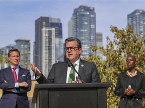 Denis Coderre is flanked by Ensemble Montréal candidates Guillaume Lavoie and Emilia Tamko on Tuesday October 12, 2021. If elected, the party is promising $36 million to help community groups fight homelessness over the next four years.