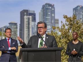 Mayoral candidate Denis Coderre, was flanked by candidates Guillaume Lavoie, left, and Emilia Tamko at a news conference on Tuesday. Coderre's plan calls for more urban farming on the island of Montreal and more protections for green spaces.