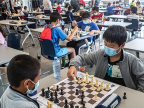 Kevin Sun, right, makes his move against Wen Hanson at the chess tournament that was launched by Nelligan MNA Monsef Derraji, in partnership with the Quebec Chess Federation, on Saturday at CEGEP Gérald-Godin in Ste-Geneviève. Students from seven local schools participated.