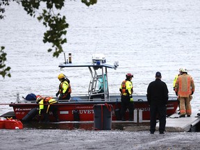 Rescuers search for a firefighter missing in the St. Lawrence River following a rescue operation on Oct. 18, 2021.