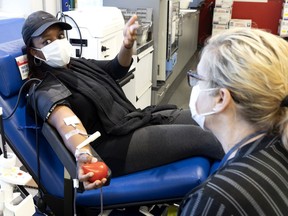 Camalyn Rose gives blood for the first time at the Héma-Québec donation centre in Montreal Oct. 18, 2021.