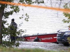 Montreal police investigate the scene on Oct. 18, 2021, after firefighter Pierre Lacroix died during a rescue operation on the Lachine Rapids.