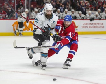 Montreal Canadiens' Joel Armia forechecks San Jose Sharks' Brent Burns during first period at the Bell Centre Tuesday, Oct. 19, 2021.