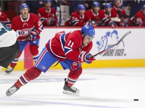 Montreal Canadiens' Brendan Gallagher sidesteps a check by San Jose Sharks' Jasper Weatherby during third period in Montreal on Oct. 19, 2021.
