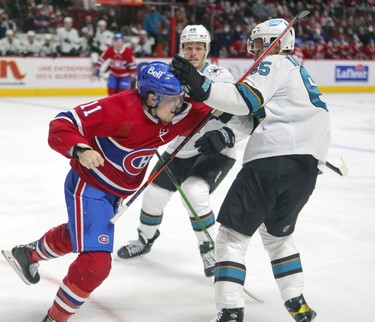 San Jose Sharks' Erik Karlsson uses his reach to hold off punch from Montreal Canadiens' Brendan Gallagher during first period at the Bell Centre Tuesday, Oct. 19, 2021.