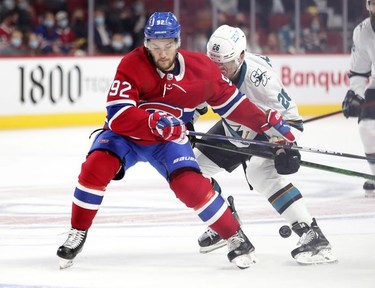 Montreal Canadiens' Jonathan Drouin fights for loose puck with San Jose Sharks' Jasper Weatherby during second period at the Bell Centre Tuesday, Oct. 19, 2021.