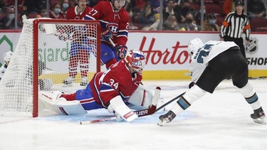 Jake Allen does the splits to foil a scoring attempt by San Jose Sharks' Jonathan Dahlen during second period at the Bell Centre Tuesday, Oct. 19, 2021.
