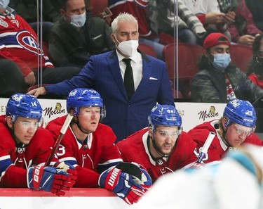 Montreal Canadiens head coach Dominique Ducharme watches the play while standing behind Nick Suzuki, left, Tyler Toffoli, Jonathan Drouin and Christian Dvorak during third period at the Bell Centre Tuesday, Oct. 19, 2021.