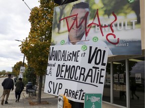 Commentary placed under a vandalized municipal election campaign poster for independent city council candidate Pascal Brault on Dorval Ave. in Dorval on Tuesday.