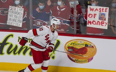 Former Montreal Canadien Jesperi Kotkaniemi skates by fans with different views during warmup with his Carolina Hurricanes prior to game at the Bell Centre on Thursday, Oct. 21, 2021.