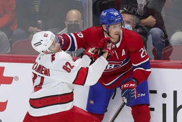 Carolina Hurricanes' Jesperi Kotkaniemi gets a glove to the face from former teammate Jeff Petry of the Montreal Canadiens during first period at the Bell Centre Thursday, Oct. 21, 2021.