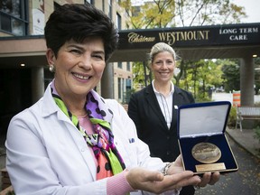 Zara Pilian, general manager, Château Westmount, holds the Medal of the National Assembly given to the establishment on Friday October 22, 2021 by MNA Jennifer Maccarone, background, for its "dedication and resilience" during the pandemic.