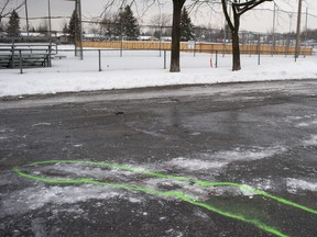 Police markings outline an area where blood stains mark the spot of a stabbing in Marc Aurèle Fortin Park north of Montreal on Thursday, January 2, 2020.