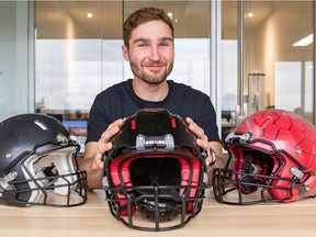 Franck Le Navéaux with a final prototype of a Kollide football helmet, flanked by earlier versions. He is the research coordinator of the Kollide consortium of four Montreal companies which designed the helmet.
