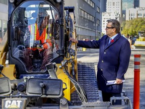 Mayoral candidate Denis Coderre speaks with a construction worker after holding a news conference near the Peel St. construction site in Montreal Thursday Oct. 28, 2021.