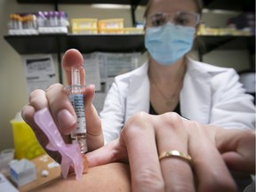 Nurse Jessica Mann Bourgouin administers a flu shot on Oct. 29, 2020, during the second wave of the COVID-19 pandemic.