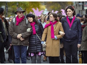 The parents and siblings of Romane Bonnier lead a large group of friends and supporters through the McGill Ghetto in Montreal on Saturday, Oct. 30, 2021, on the way to the Rialto Theatre for the funeral of the young woman who was stabbed to death in Montreal last week.