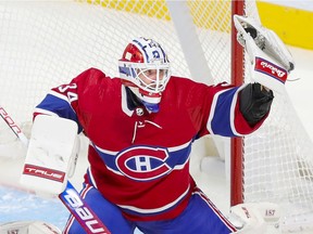 Montreal Canadiens' Jake Allen makes a glove save during third period against the Carolina Hurricanes in Montreal on Oct. 21, 2021.
