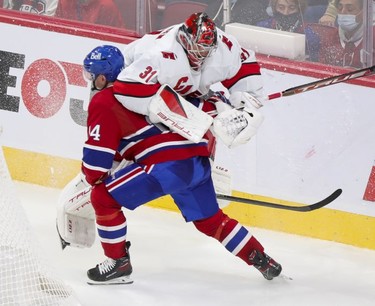Montreal Canadiens' Nick Suzuki collides with Carolina Hurricanes goalie' Frederik Andersen during second period at the Bell Centre Thursday, Oct.21, 2021.