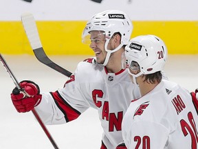 Hurricanes' Jesperi Kotkaniemi celebrates his third-period goal with teammate Sebastian Aho Thursday night at the Bell Centre. Kotkaniemi signed a $6.1-million contract with Carolina during the off-season.