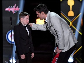 Carey Price of the Montreal Canadiens presents friend Anderson Whitehead a jersey and a trip to the 2020 NHL All-Star Game during the 2019 NHL Awards on June 19, 2019, in Las Vegas.