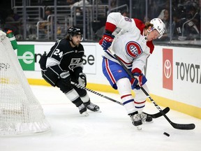 Canadiens' Christian Dvorak skates the puck against former Hab Phillip Danault (24) of the Los Angeles Kings in the first period at Staples Center on Saturday, Oct. 30, 2021, in Los Angeles.