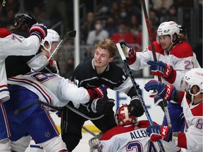 Kings' Lias Andersson loses his helmet while crashing into Canadiens' Jake Allen (34) in the second period at Staples Center on Saturday, Oct. 30, 2021, in Los Angeles.