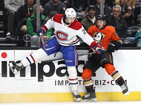 Canadiens' Alexander Romanov (27) collides with Vinni Lettieri of the Anaheim Ducks at Honda Center on Sunday, Oct. 31, 2021, in Anaheim, Calif.