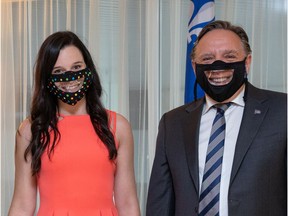 Media personality Rosalie Taillefer-Simard  and Quebec Premier François Legault wear masks with a transparent window.