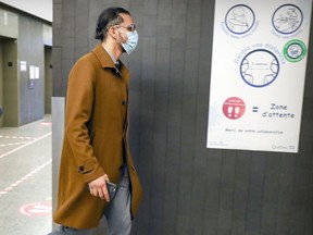 Fodil Abderhamane Lakehal walks through the halls of the Palais de Justice in Montreal during a break in his trial for manslaughter and robbery Wednesday Oct. 6, 2021.