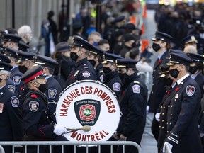 Firefighters from across Quebec and Canada arrive for the funeral services for Pierre Lacroix in Montreal Oct. 29, 2021.