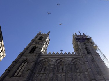 Three military helicopters perform a fly-past during the funeral service for fallen firefighter Pierre Lacroix in Montreal on Friday, Oct. 29, 2021.