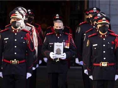 The honour guard carries the urn of fallen firefighter Pierre Lacroix during his funeral at Notre-Dame Basilica in Montreal on Friday, Oct. 29, 2021.