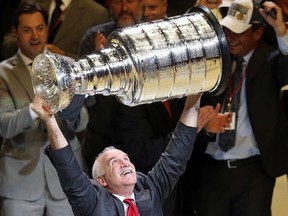 Head coach Joel Quenneville of the Chicago Blackhawks celebrates by hoisting the Stanley Cup after defeating the Tampa Bay Lightning 2-0 in Game 6 to win the 2015 Stanley Cup final at the United Center on June 15, 2015, in Chicago.