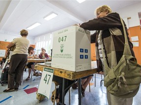 People vote on Sept. 4, 2012 in L'Assomption, Quebec.