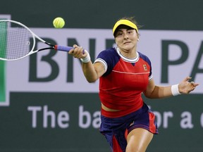 Canadian Bianca Andreescu returns a shot to Alison Riske during the BNP Paribas Open at the Indian Wells Tennis Garden in Indian Wells, Calif., on Saturday, Oct. 9, 2021.