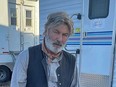 Alec Baldwin posted a picture of himself on Instagram sporting a grey beard and dressed in Western cowboy-style attire in front of trailers on the set of Rust.