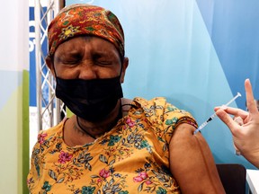 An Israeli woman receives her third dose of the coronavirus disease (COVID-19) vaccine, in Jerusalem, October 3, 2021.