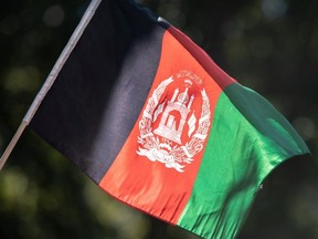 A person holds a flag of Afghanistan while taking part in a Solidarity With Afghan Women rally outside the United Nations headquarters, during the 76th Session of the U.N. General Assembly, in New York, U.S., September 25, 2021.