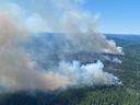 A wildfire burns southwest of Deka Lake, B.C., in July 2021. University graduates have little if any formal education about not just the science of global environmental change, but about the colossal collective tasks ahead, write Keroles B. Riad and Peter Stoett.