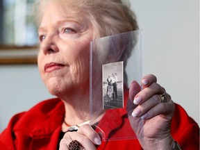 Diane Capone, granddaughter of American gangster Al Capone, talks about her memories of him while holding a photo that featured both of them and other family members in 1946.