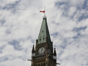 The Canadian flag flies at half-staff on the Peace Tower at Parliament Hill in recognition of the discovery of unmarked indigenous graves at residential schools on Canada Day, Thursday, July 1, 2021.