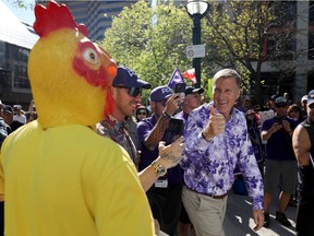 Maxime Bernier, head of the People's Party of Canada, gives a thumbs-up to someone in a rubber chicken outfit during a protest outside CBC headquarters in Toronto ahead of the 2021 federal election.