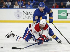 Montreal Canadiens forward Mathieu Perreault is brought down by Buffalo Sabres defenceman Henri Jokiharju during the second period on Oct. 14, 2021, in Buffalo.