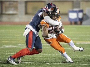 Montreal Alouettes' Chris Ackie tackles B.C. Lions' James Butler during second half in Montreal on Sept. 18, 2021.